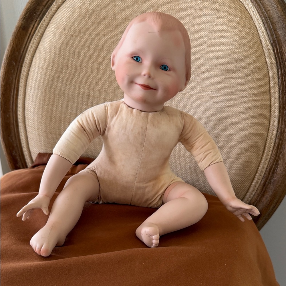 1989 Vintage Porcelain/Bisque Baby Doll in Cream Bodysuit with Blue Eyes
